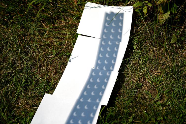 Using a piece of pegboard the lunar eclipse is projected on pieces of paper at the Montshire Museum of Science in Norwich, Vt., on Aug. 21, 2017. (Valley News - Jennifer Hauck) Copyright Valley News. May not be reprinted or used online without permission. Send requests to permission@vnews.com.