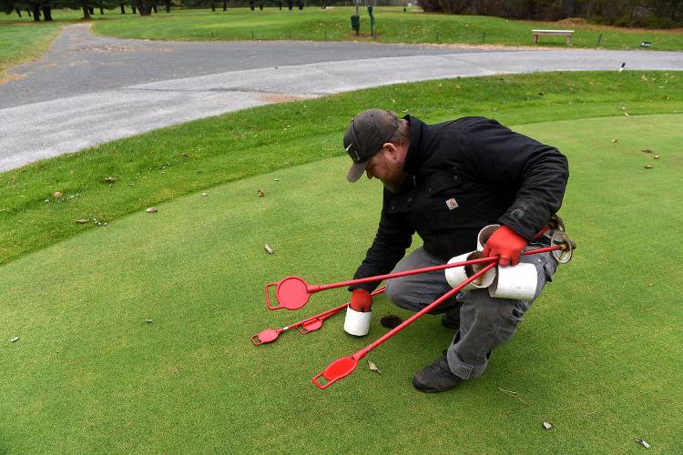Matt Maxham, general manager of the Carter Country Club, picks up half putting cups at the club in Lebanon, N.H., on Nov. 5, 2018. Monday was their last day for the season.  (Valley News - Jennifer Hauck) Copyright Valley News. May not be reprinted or used online without permission. Send requests to permission@vnews.com.