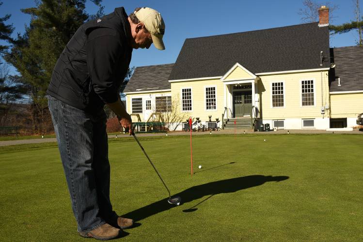 Dave Hollis practices his putting outside the club house at the Carter Country Club where he works in Lebanon, N.H. Monday, November 9, 2015. The course was built in 1923 and may now be moved and rebuilt as part of a redevelopment by owner Doug Homan. (Valley News - James M. Patterson)
<p><i>Copyright © Valley News. May not be reprinted or used online without permission. Send requests to permission@vnews.com.</i></p> Dave Hollis practices his putting on Monday outside the club house at the Carter Country Club where he works in Lebanon. The course was built in 1923 and may now be moved and rebuilt as part of a redevelopment by owner Doug Homan. After more than four months of delays, the Lebanon Planning Board began its review Monday of Homan’s proposal to move the course and construct about 300 homes on the land.Valley News — James M. Patterson    