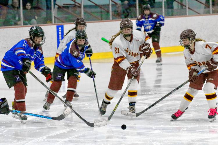 Mirabella Orlen, right, and Abby Auch (21) of Lebanon-Stevens-Kearsarge pursue the puck against Oyster River-Portsmouth on Feb. 10, 2024, at Campion Rink in West Lebanon, N.H. Oyster River-Portsmouth won the NHIAA game, 3-0. (Valley News - Tris Wykes) Copyright Valley News. May not be reprinted or used online without permission. 