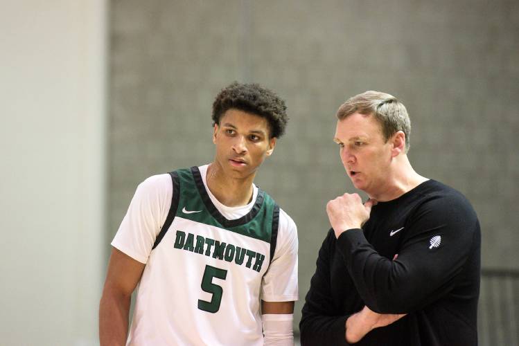 Dartmouth College men’s basketball Coach David McLaughlin, right, talks with senior Jaren Johnson, left, as a teammate takes a foul shot during a game with Westfield State at Leede Arena in Hanover, N.H., on Wednesday, Nov. 16, 2023.  Dartmouth won 79-61. (Valley News - James M. Patterson) Copyright Valley News. May not be reprinted or used online without permission. Send requests to permission@vnews.com.