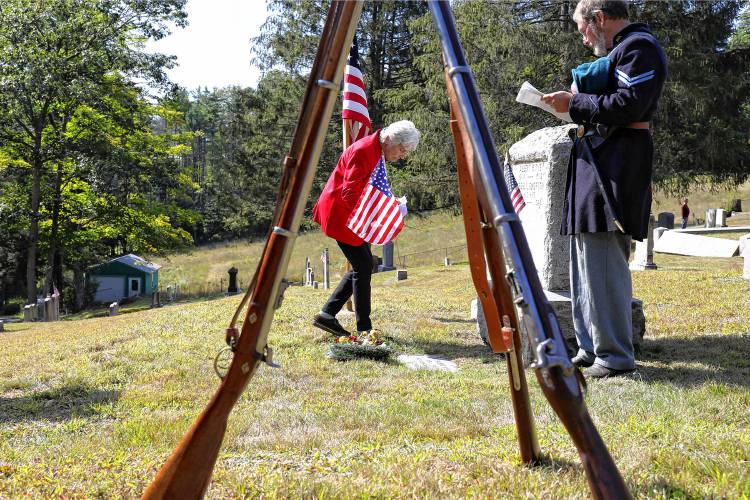 Fran Hanchett, with the Mary Elizabeth Kimball Auxiliary, places a Civil War-age flag on the grace of Albert Nye, a Civil War veteran, during a memorial for Civil War veterans on Saturday, Sept. 02, 2017, at Hillside Cemetery in Norwich, Vt. Hanchett said she has found about 100 Civil War veterans from Lebanon. (Valley News - Charles Hatcher) Copyright Valley News. May not be reprinted or used online without permission. Send requests to permission@vnews.com.