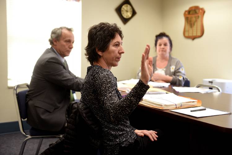 Louise Clarke, a part owner and  general manager at Three Tomatoes Trattoria, is sworn in during a wage claim hearing at the New Hampshire Department of Labor in Concord, N.H., on Tuesday, Feb. 6, 2024. Seated next to her is her attorney Brad Wilder. Across the table is Jennifer Kahn, a long time server at the restaurant, who brought the case to the labor department. (Valley News - Jennifer Hauck) Copyright Valley News. May not be reprinted or used online without permission. Send requests to permission@vnews.com.