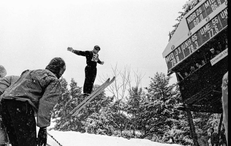 Jumping for good distance in the annual Dartmouth Winter Carnival in a blinding snowstorm is Roger Dion of Paul Smith's College and Lebanon, N.H., on Feb. 5, 1961. Dion won the jumping event. (Valley News - Larry McDonald) Copyright Valley News. May not be reprinted or used online without permission. Send requests to permission@vnews.com.